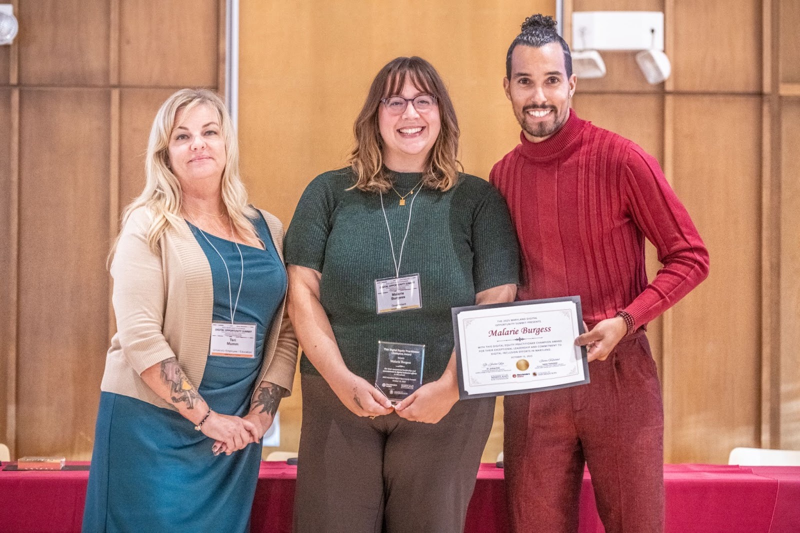 Pictured: Malarie Burgess accepts the Practitioner Award alongside Teri Mumm (left) and Ronnie Hammond (right).